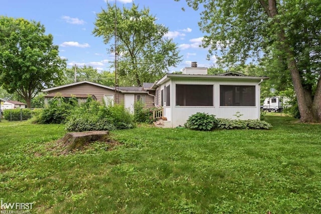 5232 Maple Ave, Swartz Creek, MI 48473 - view of side of home with a chimney, a sunroom, and a lawn
