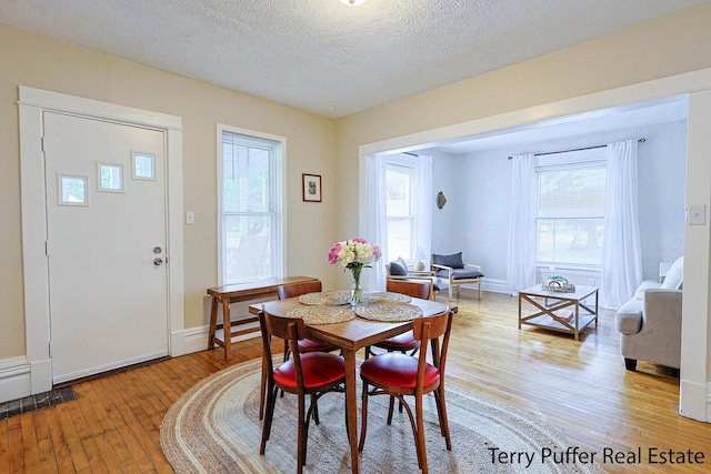 2550 Crozier Ave, Muskegon, MI 49441 - dining space with light wood-type flooring and a textured ceiling