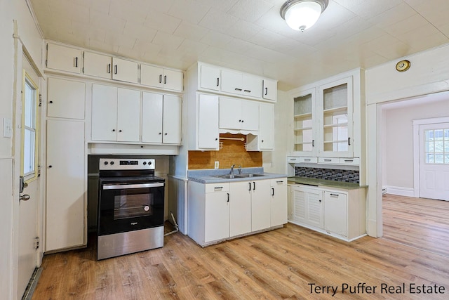 2550 Crozier Ave, Muskegon, MI 49441 - kitchen with electric stove, decorative backsplash, white cabinets, light wood finished floors, and glass insert cabinets