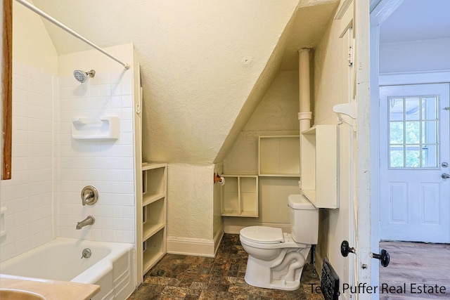 2550 Crozier Ave, Muskegon, MI 49441 - full bath featuring vaulted ceiling,  shower combination, and a textured wall