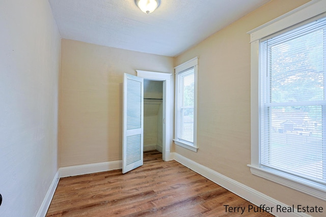 2550 Crozier Ave, Muskegon, MI 49441 - unfurnished bedroom with wood finished floors and a closet