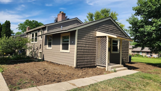 2637 Pittsfield Blvd, Ann Arbor, MI 48104 - view of property exterior featuring a chimney and a yard