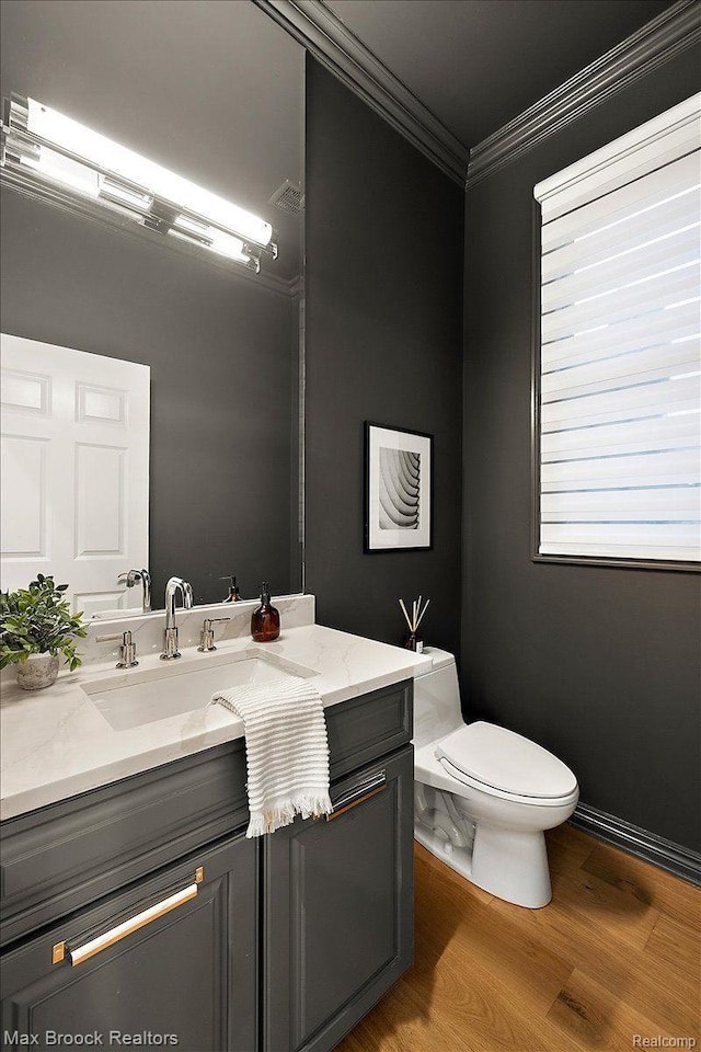 855 Wallace St, Birmingham, MI 48009 - half bathroom with ornamental molding, vanity, and wood finished floors