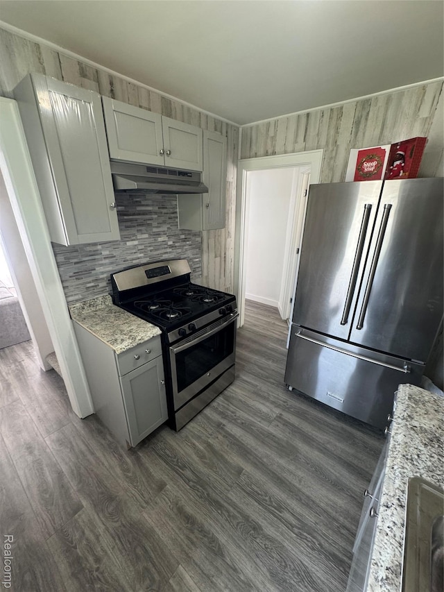 20789 Marie Ave, Warren, MI 48089 - kitchen featuring stainless steel appliances, under cabinet range hood, dark wood-style floors, and backsplash