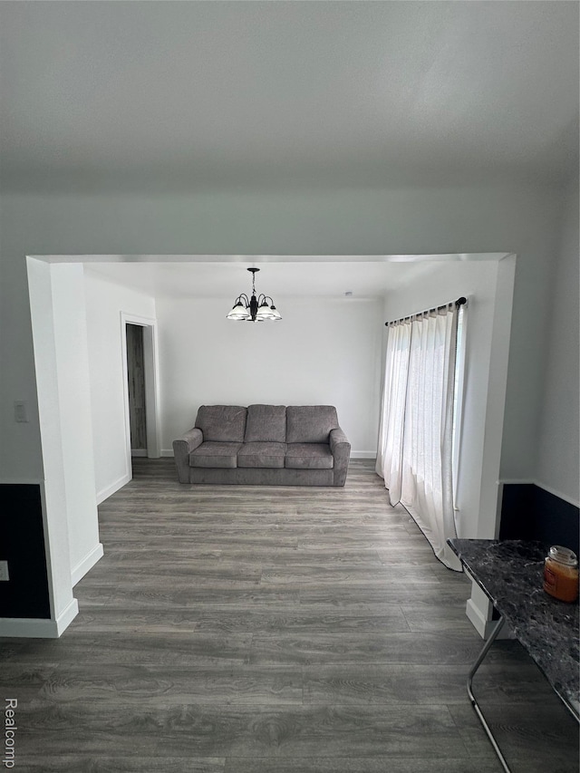20789 Marie Ave, Warren, MI 48089 - living room featuring a chandelier and dark wood-style flooring