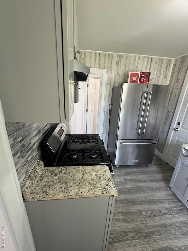 20789 Marie Ave, Warren, MI 48089 - kitchen featuring high end refrigerator, range with gas cooktop, exhaust hood, dark wood-style flooring, and backsplash