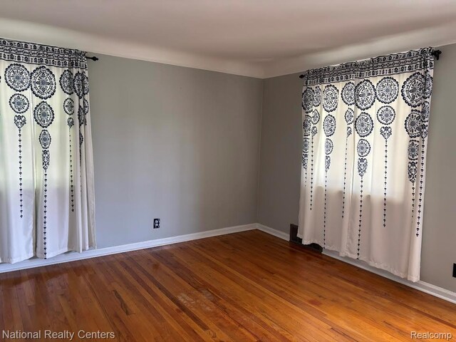 1618 E Lincoln Ave, Royal Oak, MI 48067 - unfurnished room with wood finished floors and baseboards