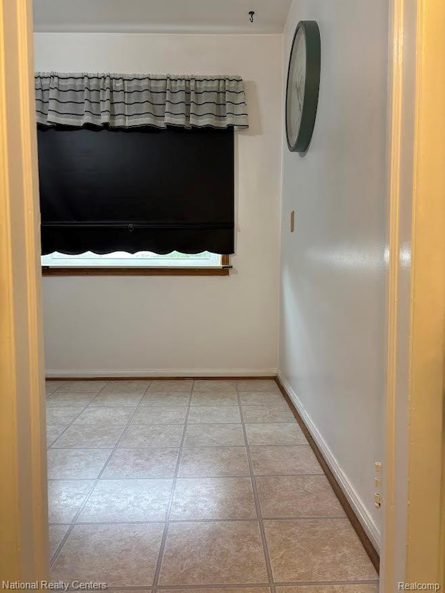 1618 E Lincoln Ave, Royal Oak, MI 48067 - empty room with baseboards and light tile patterned floors