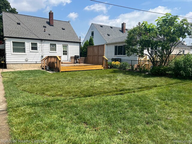 1618 E Lincoln Ave, Royal Oak, MI 48067 - rear view of house with a wooden deck, a chimney, and roof with shingles