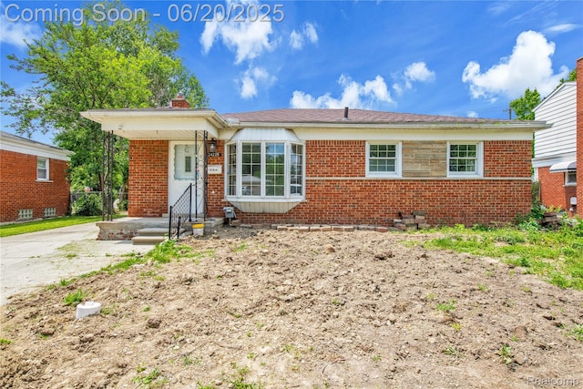24225 Prairie Ln, Warren, MI 48089 - view of front of property with a chimney and brick siding