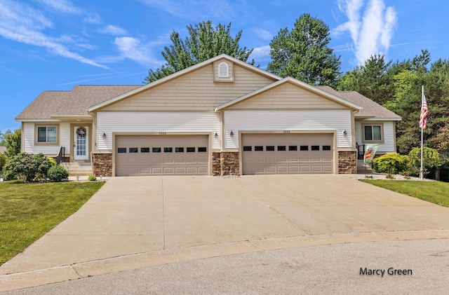 5589 Sandalwood Ct Unit 22, Norton Shores, MI 49441 - view of front of property with stone siding, a garage, driveway, a front yard, and a shingled roof