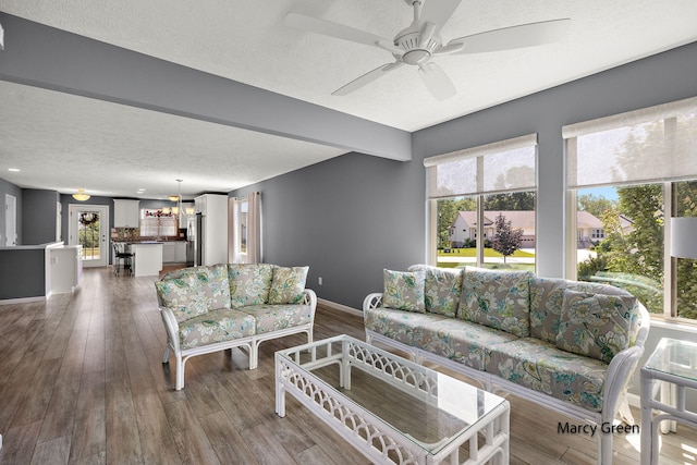 5589 Sandalwood Ct Unit 22, Norton Shores, MI 49441 - living area featuring healthy amount of natural light, a textured ceiling, wood finished floors, and ceiling fan