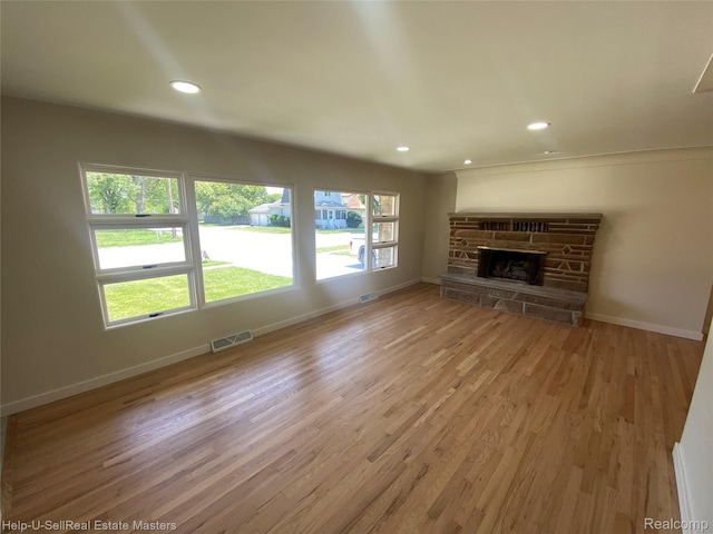 2705 Stone St, Port Huron, MI 48060 - unfurnished living room featuring light wood-type flooring, recessed lighting, and a fireplace