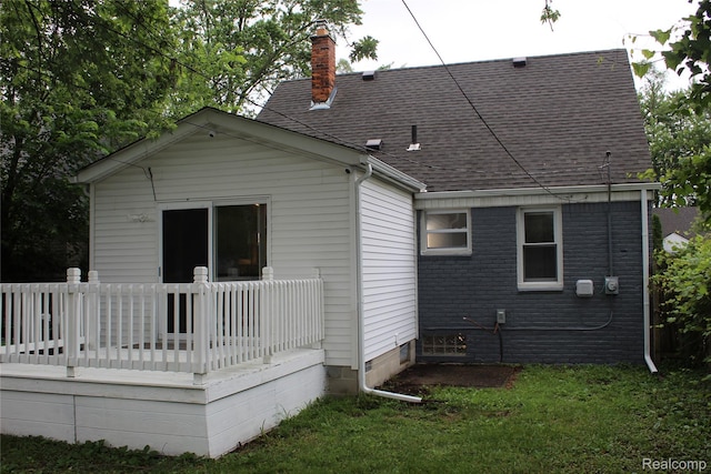 20153 Hartwell St, Detroit, MI 48235 - back of property with a wooden deck, a chimney, and a shingled roof