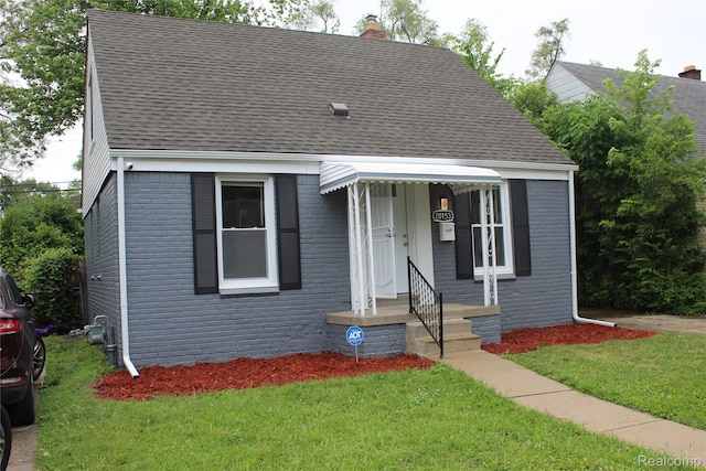 20153 Hartwell St, Detroit, MI 48235 - bungalow with a shingled roof, a chimney, a front lawn, and brick siding