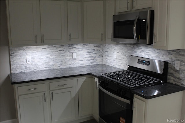 20153 Hartwell St, Detroit, MI 48235 - kitchen with appliances with stainless steel finishes, dark countertops, decorative backsplash, and white cabinetry