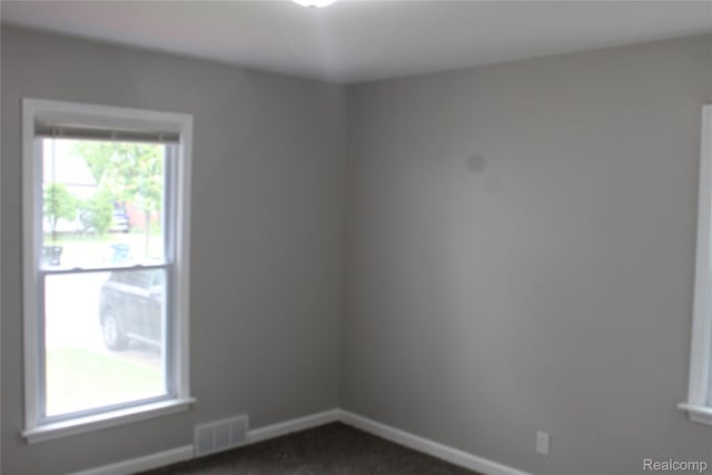 20153 Hartwell St, Detroit, MI 48235 - spare room featuring dark carpet and baseboards