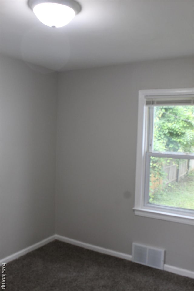 20153 Hartwell St, Detroit, MI 48235 - empty room featuring dark carpet and baseboards