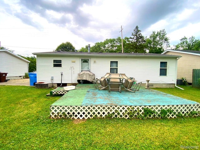 5424 Hughes Rd, Lansing, MI 48911 - rear view of house with a wooden deck and a lawn