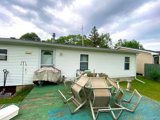 5424 Hughes Rd, Lansing, MI 48911 - rear view of house with a lawn and a wooden deck