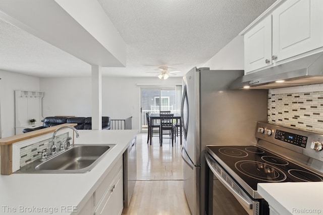 9451 Parkwood N, Davison, MI 48423 - kitchen featuring appliances with stainless steel finishes, decorative backsplash, a ceiling fan, under cabinet range hood, and a textured ceiling