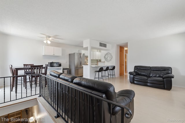 9451 Parkwood N, Davison, MI 48423 - living room with a ceiling fan, light wood-style floors, and a textured ceiling