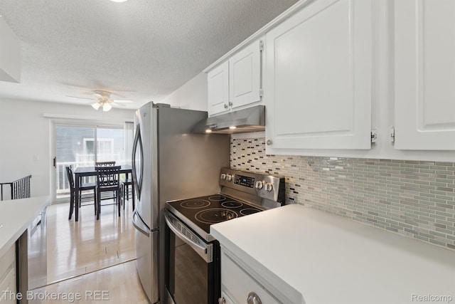 9451 Parkwood N, Davison, MI 48423 - kitchen featuring electric stove, under cabinet range hood, ceiling fan, a textured ceiling, and white cabinetry
