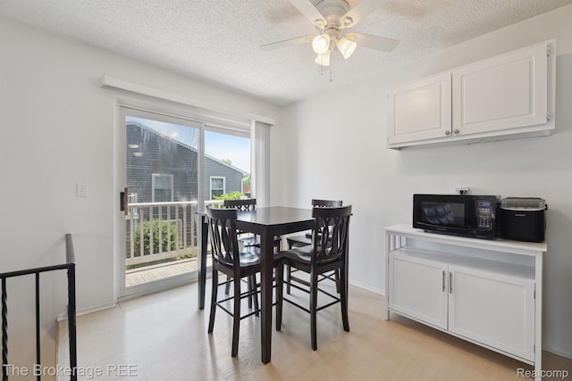 9451 Parkwood N, Davison, MI 48423 - dining space featuring light wood finished floors, ceiling fan, and a textured ceiling
