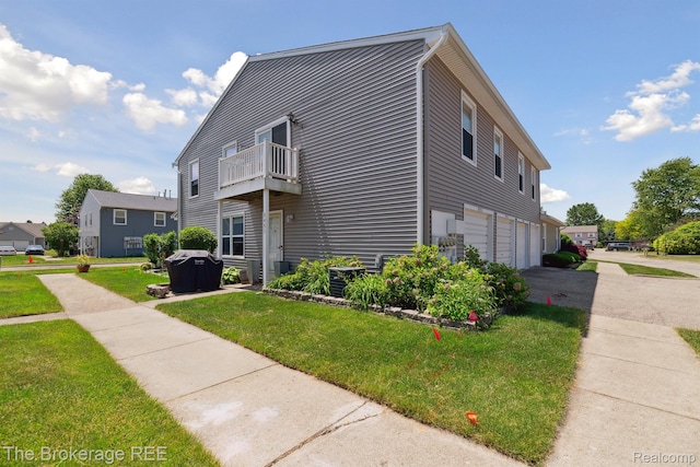 9451 Parkwood N, Davison, MI 48423 - view of side of home with a balcony, driveway, a yard, and an attached garage