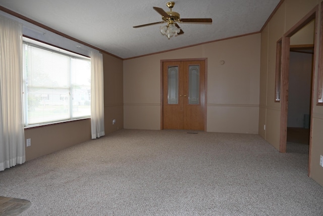 4105 Sawgrass Trl, Muskegon, MI 49442 - empty room featuring vaulted ceiling, carpet flooring, ceiling fan, ornamental molding, and a textured ceiling