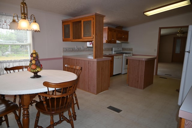 4105 Sawgrass Trl, Muskegon, MI 49442 - kitchen with white appliances, a peninsula, extractor fan, brown cabinets, and glass insert cabinets