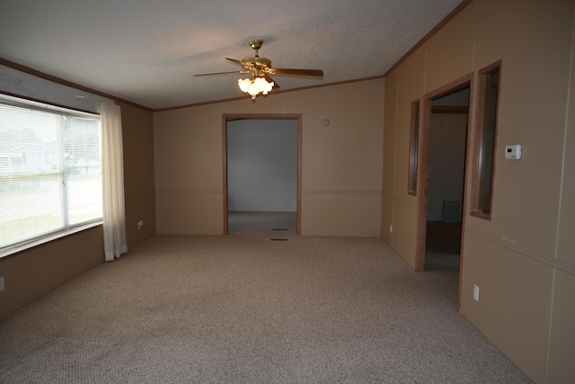 4105 Sawgrass Trl, Muskegon, MI 49442 - spare room with crown molding, light carpet, and ceiling fan