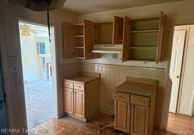 3929 Grayton St, Detroit, MI 48224 - kitchen with under cabinet range hood, open shelves, and tile walls
