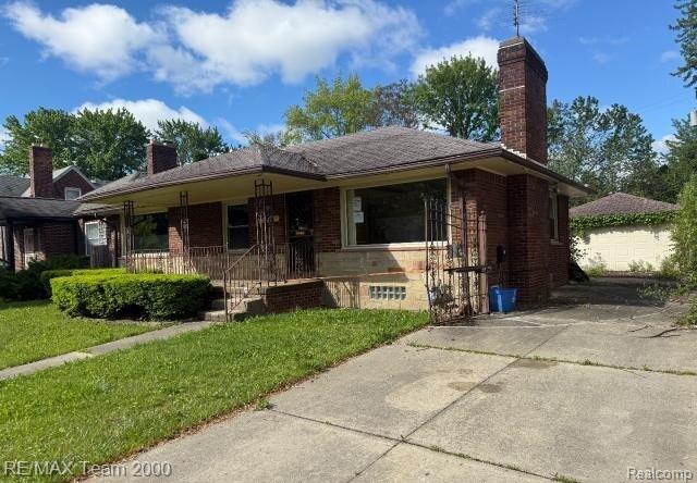 3929 Grayton St, Detroit, MI 48224 - ranch-style house with a chimney, a porch, brick siding, and a front yard