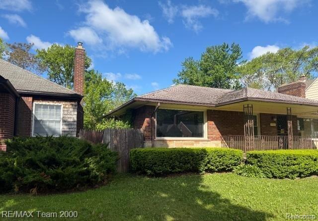 3929 Grayton St, Detroit, MI 48224 - back of property featuring a chimney, brick siding, and a garage
