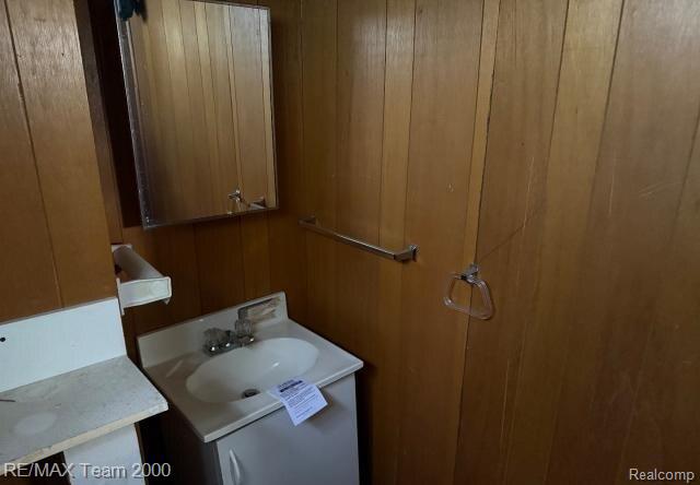3929 Grayton St, Detroit, MI 48224 - bathroom featuring vanity and wood walls