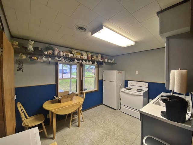 9810 E School Section Lake Dr, Mecosta, MI 49332 - kitchen featuring white appliances, light tile patterned flooring, and light countertops