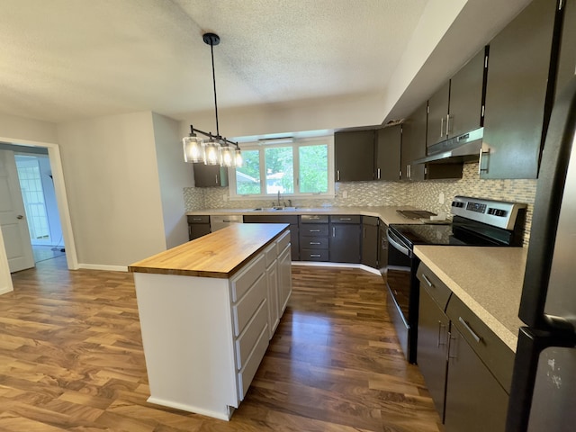 1358 Neece Dr, Norton Shores, MI 49441 - kitchen featuring under cabinet range hood, stainless steel appliances, wood counters, backsplash, and a kitchen island