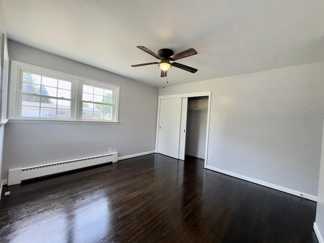 1358 Neece Dr, Norton Shores, MI 49441 - unfurnished bedroom with baseboard heating, a closet, dark wood-style floors, and ceiling fan