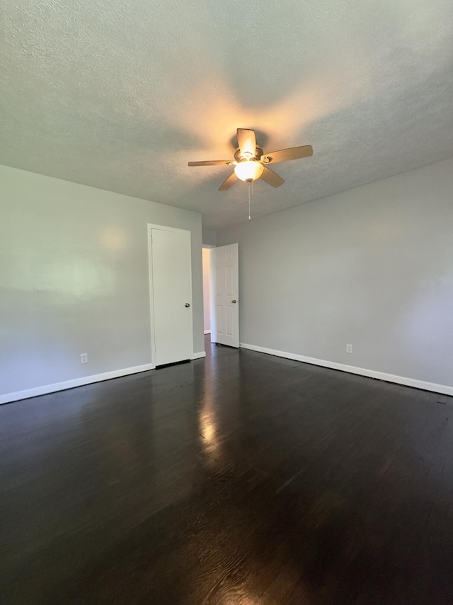 1358 Neece Dr, Norton Shores, MI 49441 - spare room with dark wood-style floors, ceiling fan, and a textured ceiling