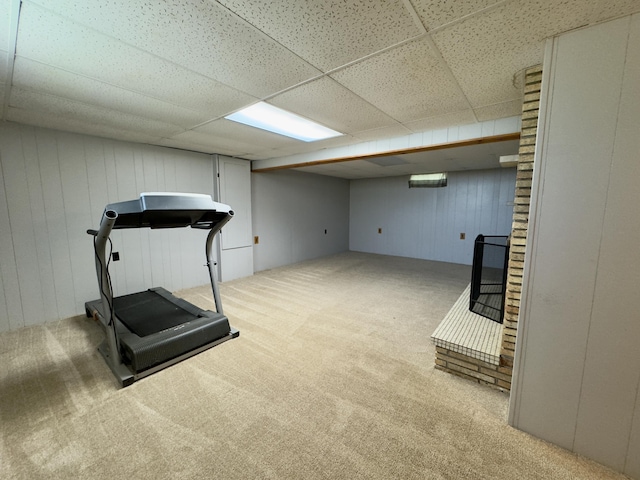 1358 Neece Dr, Norton Shores, MI 49441 - workout area featuring carpet flooring, a drop ceiling, and wood walls