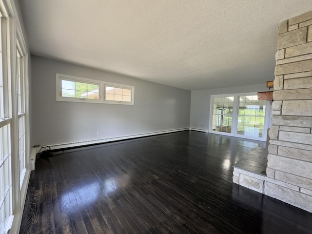 1358 Neece Dr, Norton Shores, MI 49441 - unfurnished room featuring baseboard heating, wood finished floors, and a textured ceiling