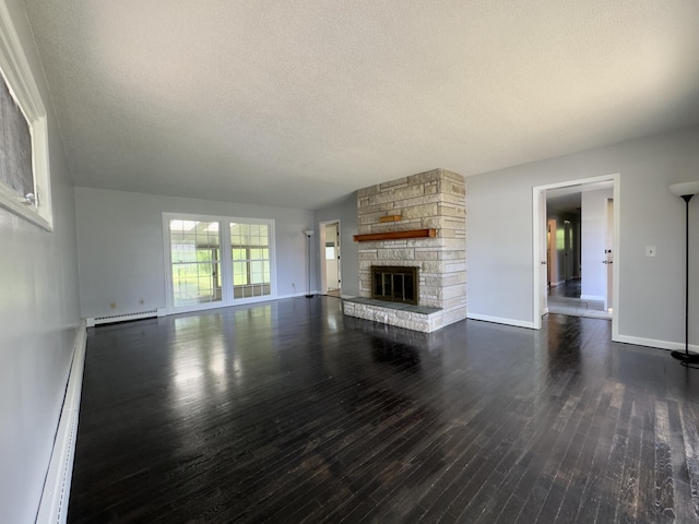1358 Neece Dr, Norton Shores, MI 49441 - unfurnished living room with a textured ceiling, dark wood-style floors, a baseboard radiator, a baseboard heating unit, and a fireplace