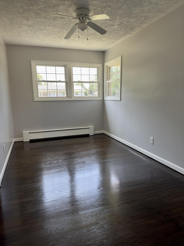 1358 Neece Dr, Norton Shores, MI 49441 - spare room featuring baseboard heating, ceiling fan, a textured ceiling, and dark wood-style flooring