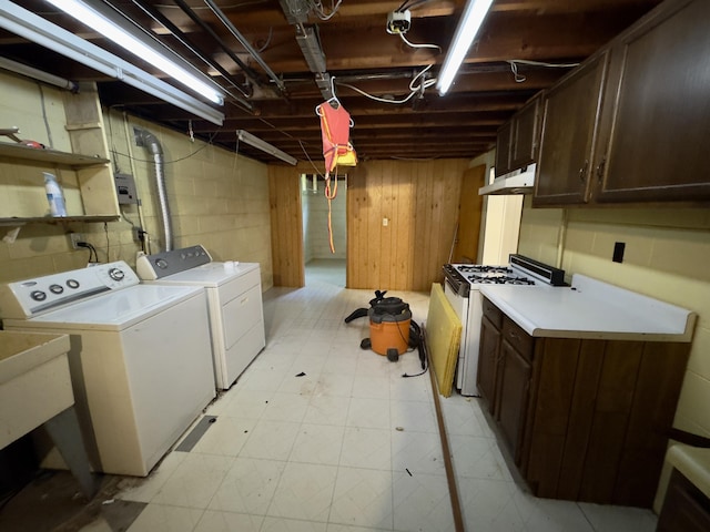 1358 Neece Dr, Norton Shores, MI 49441 - washroom featuring washer and clothes dryer, cabinet space, and light floors