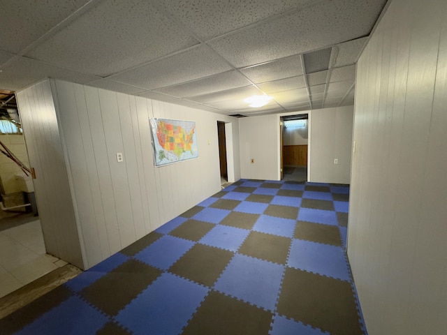 1358 Neece Dr, Norton Shores, MI 49441 - finished basement featuring tile patterned floors, a drop ceiling, and wood walls