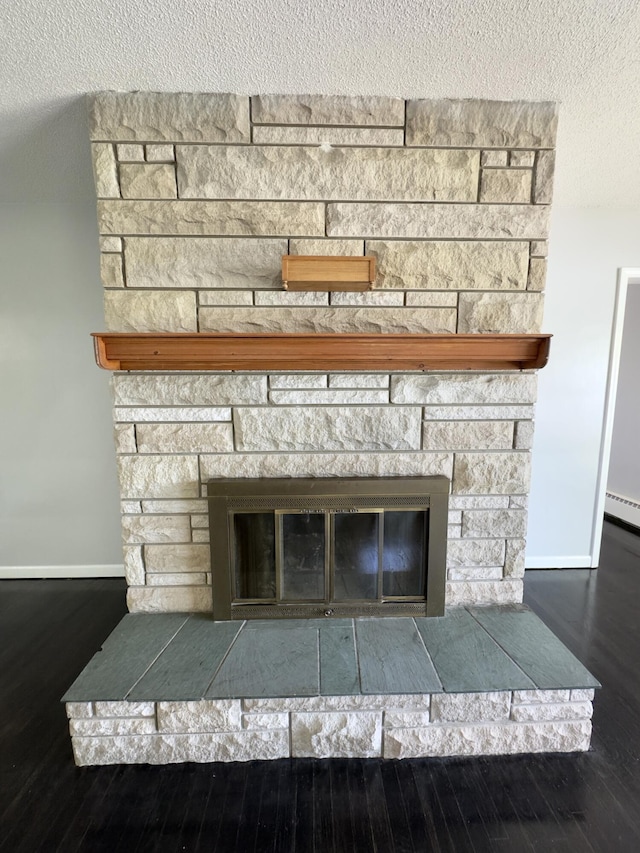 1358 Neece Dr, Norton Shores, MI 49441 - detailed view of a stone fireplace, wood finished floors, and baseboard heating