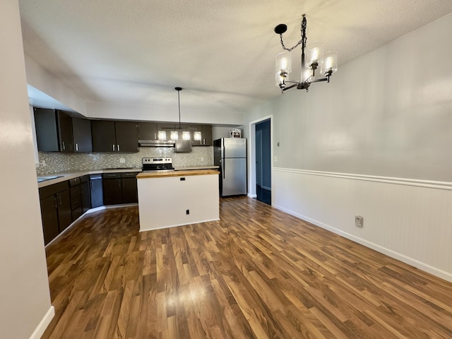 1358 Neece Dr, Norton Shores, MI 49441 - kitchen featuring appliances with stainless steel finishes, a chandelier, and dark wood finished floors