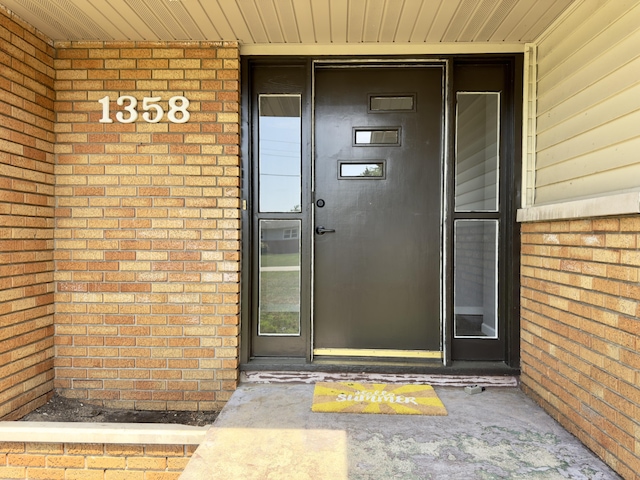 1358 Neece Dr, Norton Shores, MI 49441 - property entrance with brick siding