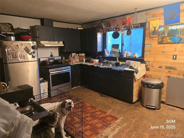 3145 Raywood St, Flint, MI 48504 - kitchen with stainless steel gas stove, freestanding refrigerator, under cabinet range hood, and dark cabinets